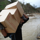 Daniel Braithwaite carries boxes of M.R.E.’s as he helps U.S. Army 1st Special Forces Command soldiers as they deliver food and water in Puerto Rico.